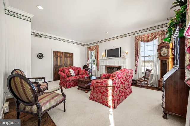 a living room with furniture fireplace and flat screen tv