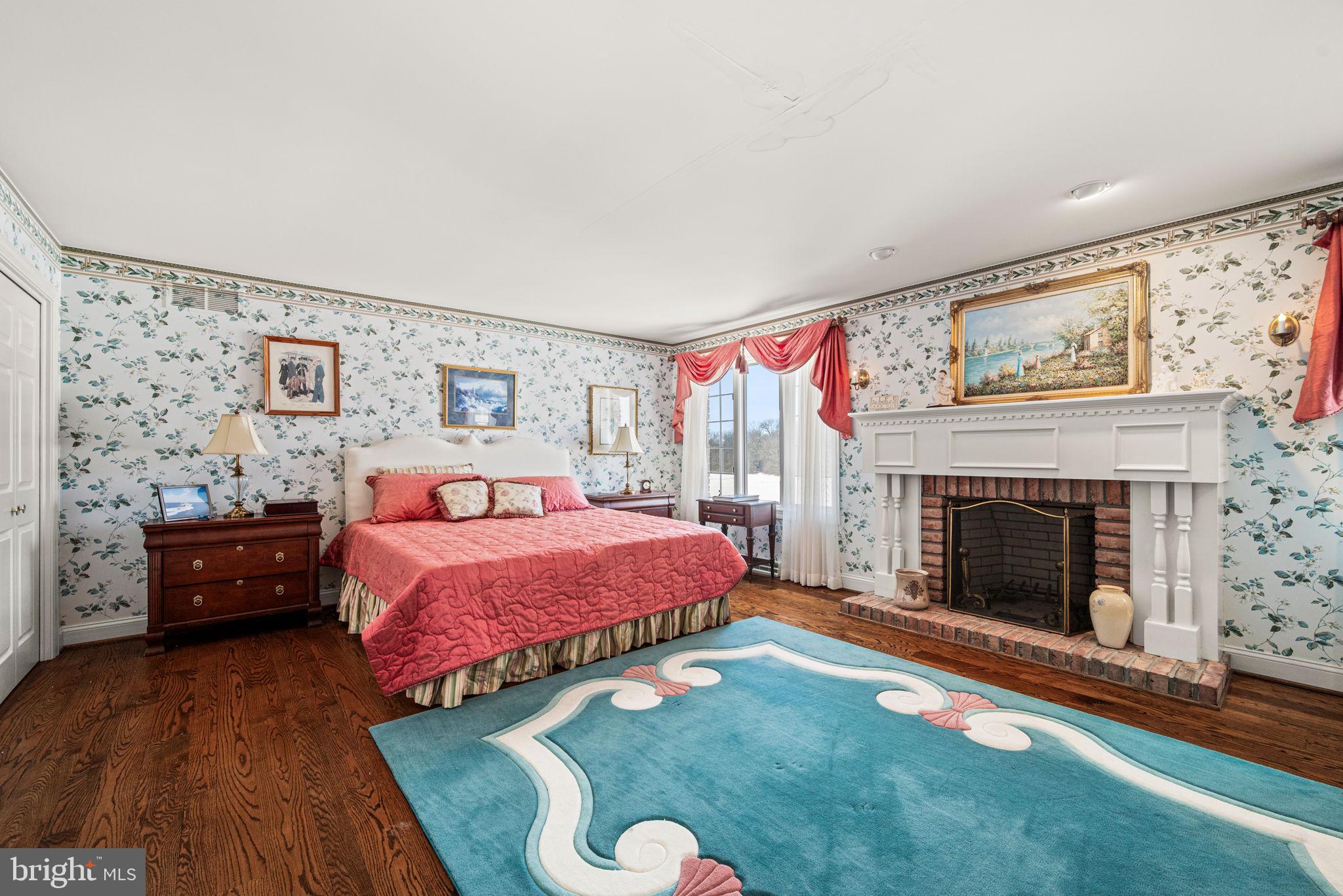 220 Sassamansville Road Gilbertsville, PA 19525 - Photo 18 of 34 a bedroom with a bed and a fireplace