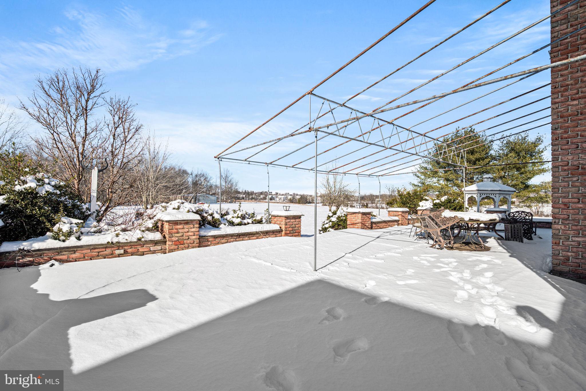 220 Sassamansville Road Gilbertsville, PA 19525 - Photo 25 of 34 a view of a patio with a table and chairs under an umbrella
