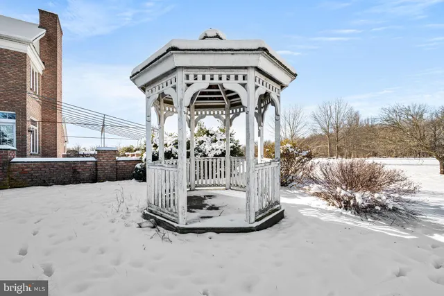 a view of a house with a snow in the background
