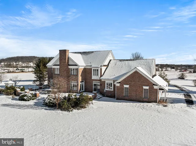 a view of a house with a snow in the background