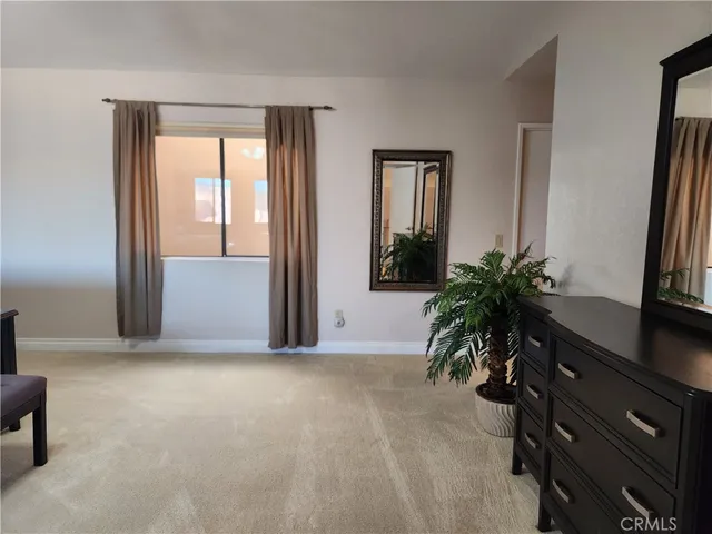 an empty room with window and front door