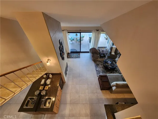 a living room with furniture and a floor to ceiling window