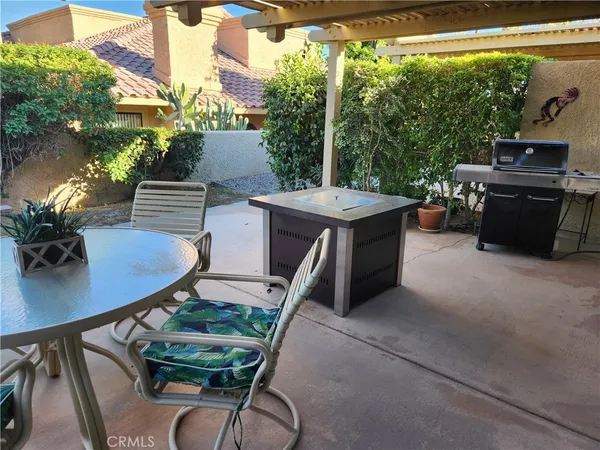 a view of a chairs and table in the patio