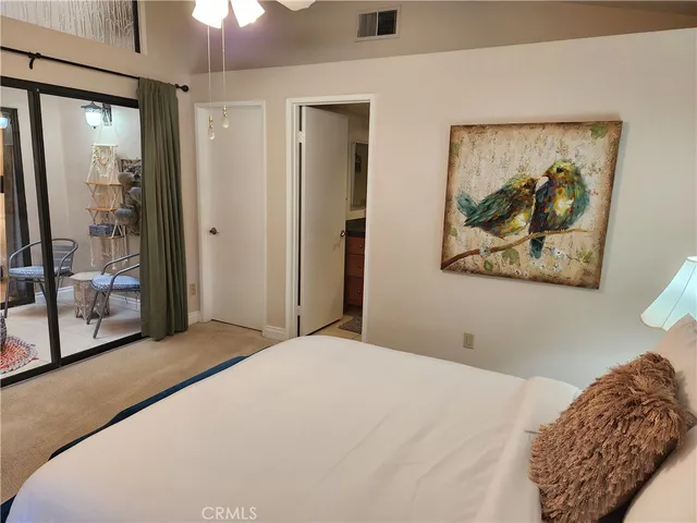 a bedroom with a large bed and a painting on the wall