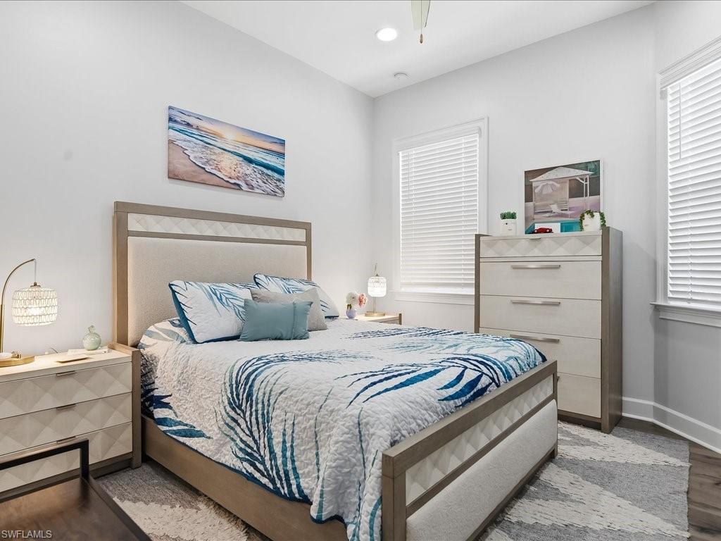6827 Saona Court Naples, FL 34113 - Photo 12 of 36 a bedroom with a bed and a window