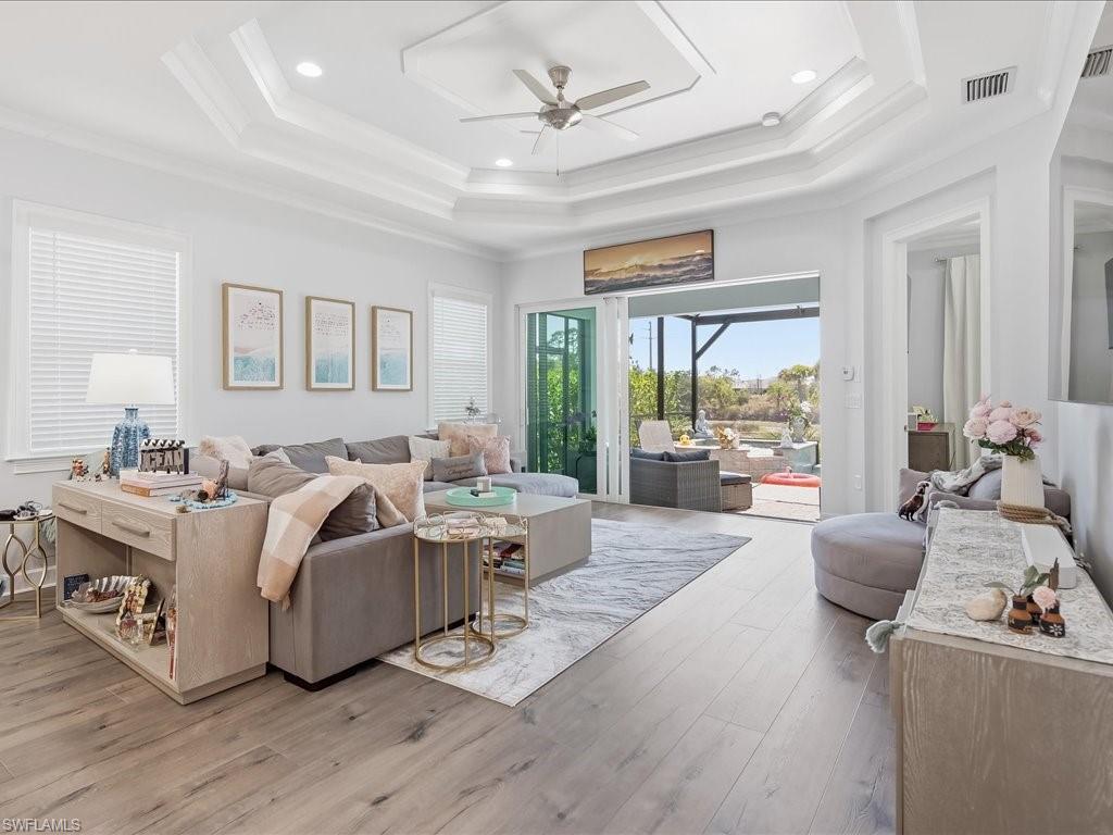 6827 Saona Court Naples, FL 34113 - Photo 15 of 36 a living room with furniture and a large window