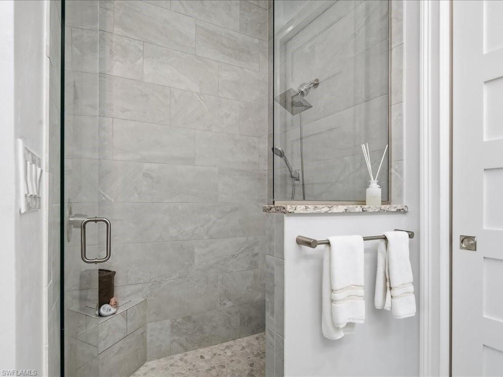 6827 Saona Court Naples, FL 34113 - Photo 23 of 36 a bathroom with a shower
