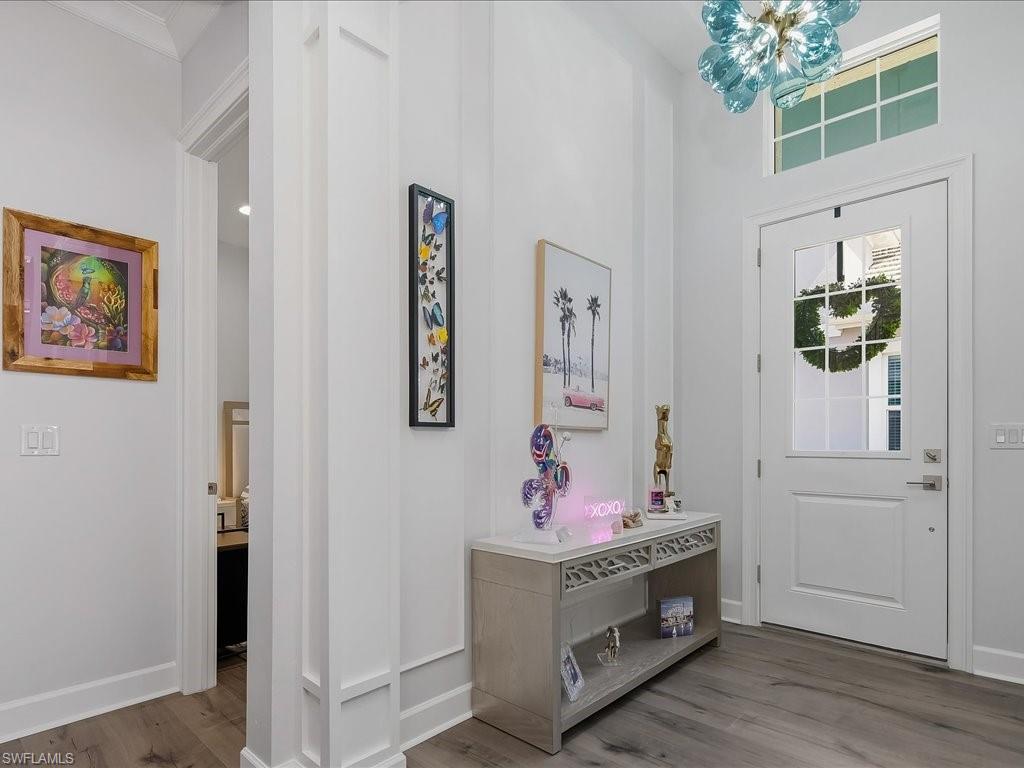 6827 Saona Court Naples, FL 34113 - Photo 25 of 36 a view of room with furniture and wooden floor