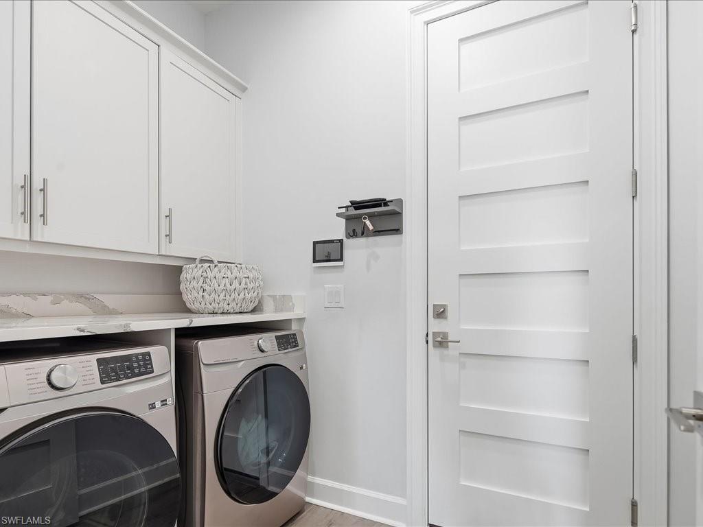 6827 Saona Court Naples, FL 34113 - Photo 26 of 36 a utility room with dryer and washer