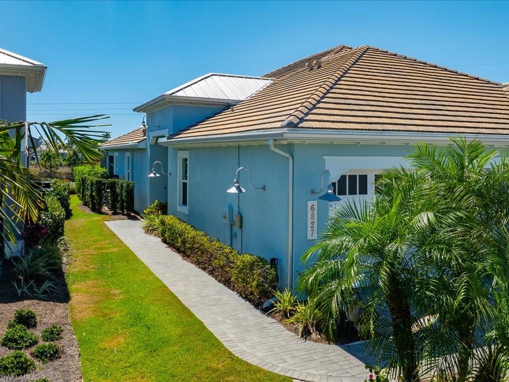 6827 Saona Court Naples, FL 34113 - Photo 27 of 36 a front view of a house with a yard