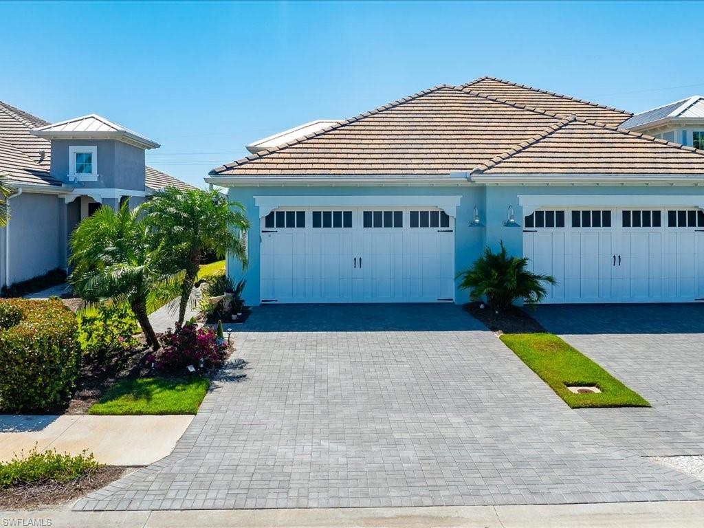 6827 Saona Court Naples, FL 34113 - Photo 28 of 36 a house view with a garden space