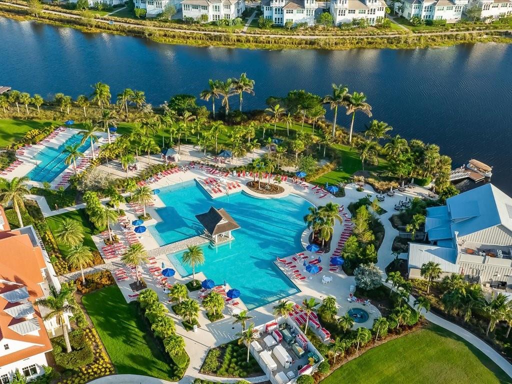 6827 Saona Court Naples, FL 34113 - Photo 32 of 36 a view of a lake with a building in the background