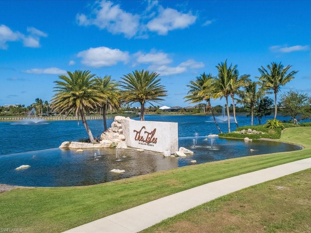 6827 Saona Court Naples, FL 34113 - Photo 36 of 36 a view of a swimming pool with a yard