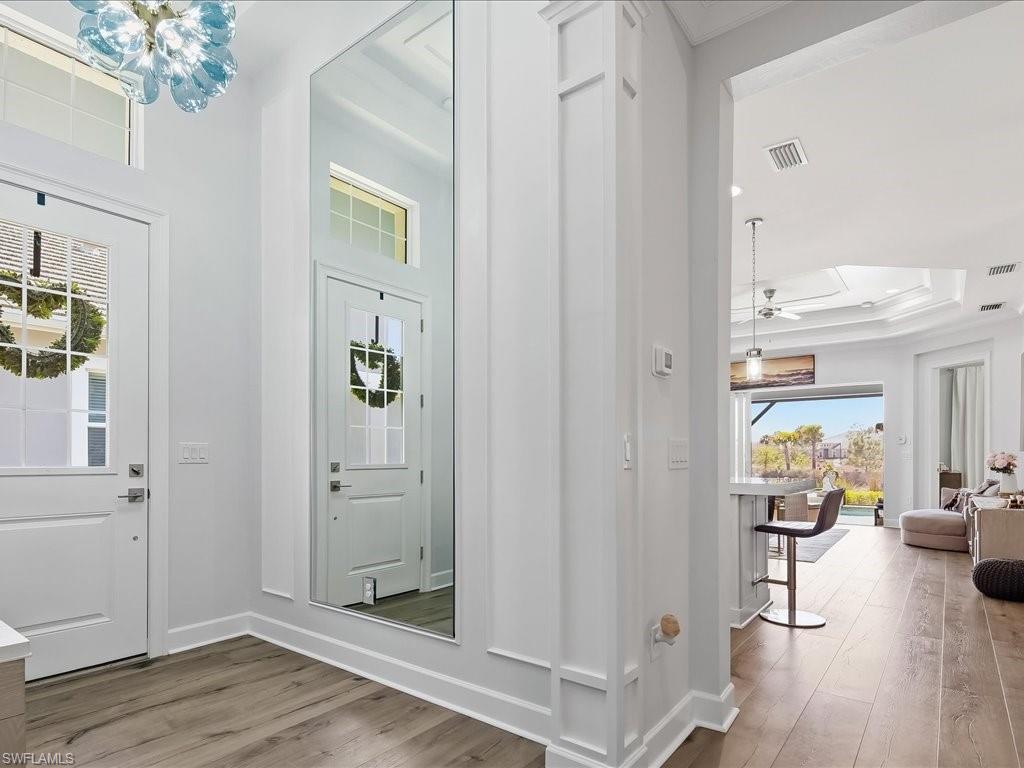 6827 Saona Court Naples, FL 34113 - Photo 6 of 36 workspace with wooden floor and windows