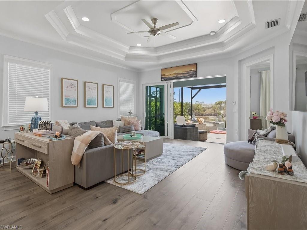 6827 Saona Court Naples, FL 34113 - Photo 8 of 36 a living room with furniture and a large window