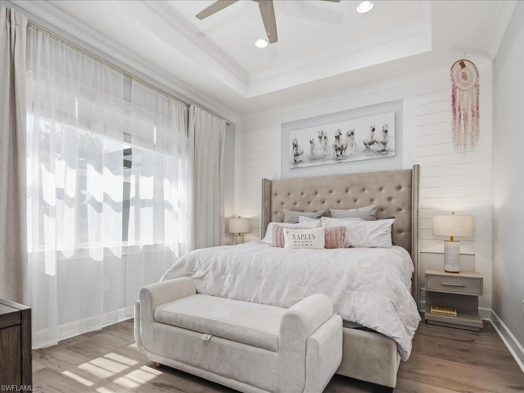 6827 Saona Court Naples, FL 34113 - Photo 10 of 36 a bedroom with a large bed and a window