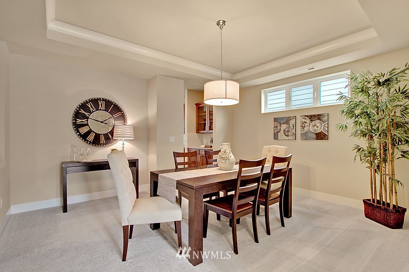 3731 226th Place Southeast Bothell, WA 98021 - Photo 12 of 16 a view of a dining room with furniture and a chandelier