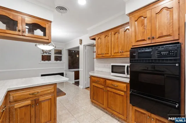 a kitchen with stainless steel appliances granite countertop a stove microwave and cabinets