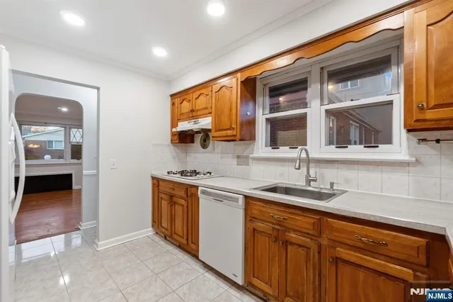 a kitchen with stainless steel appliances granite countertop a sink and a stove