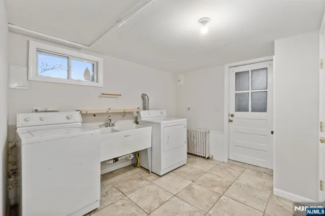 a utility room with cabinets washer and dryer