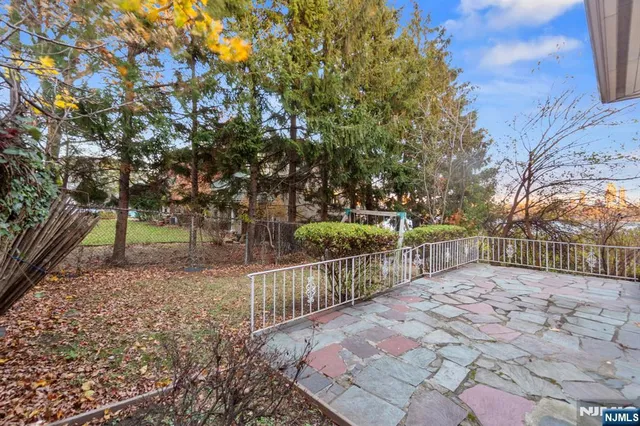 a view of a pathway with a wrought fence