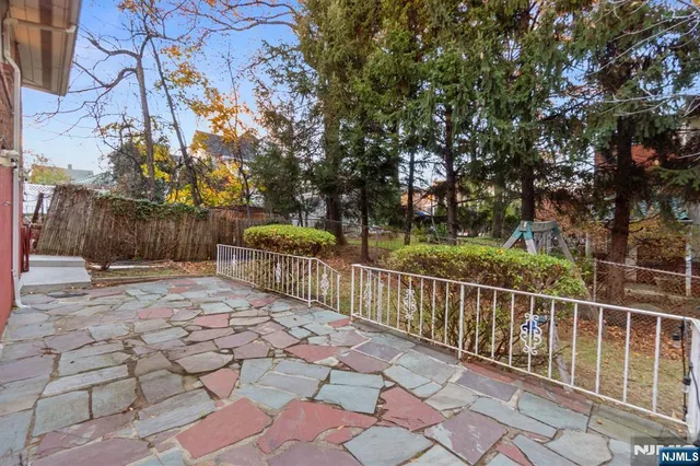 a view of a yard with wooden fence