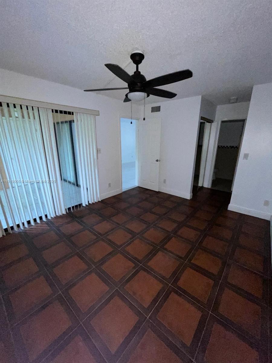3410 Foxcroft Road, Unit 310 Miramar, FL 33025 - Photo 13 of 21 a bed in a bedroom next to a window