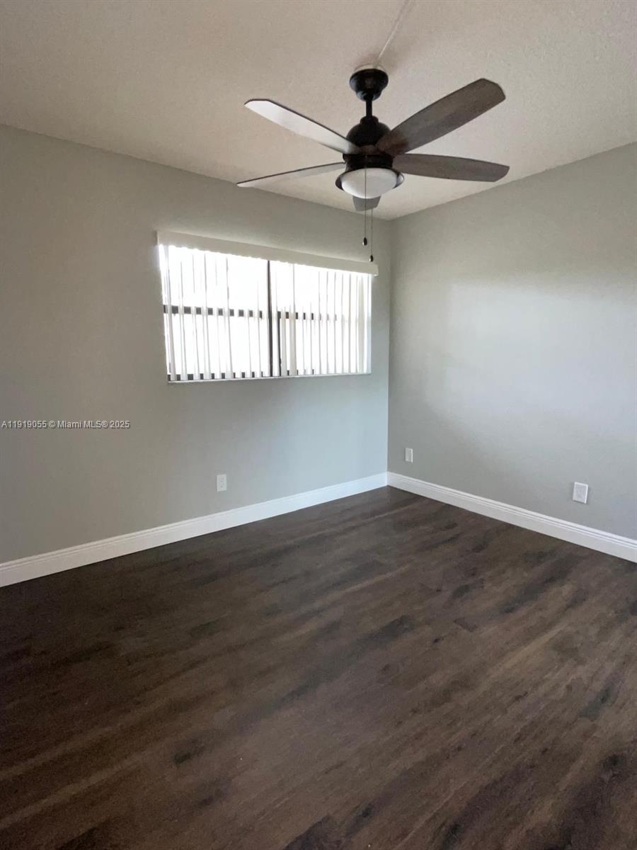 3410 Foxcroft Road, Unit 310 Miramar, FL 33025 - Photo 14 of 21 a view of an empty room with wooden floor and a window