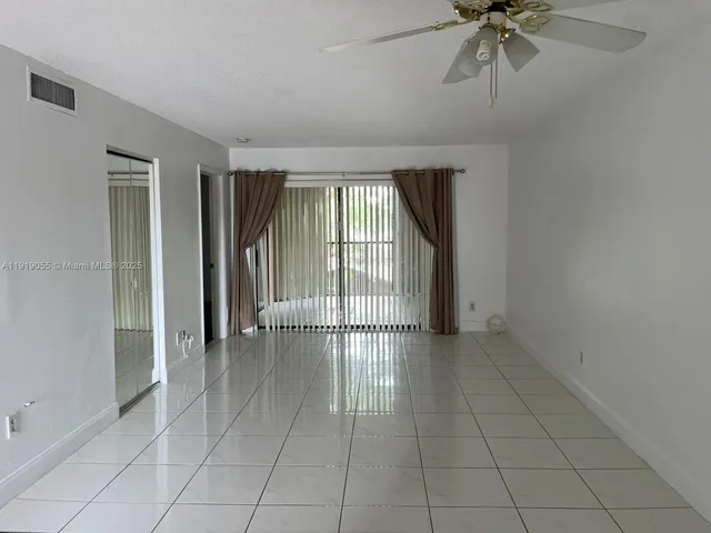 an aerial view of a house with swimming pool garden and seating