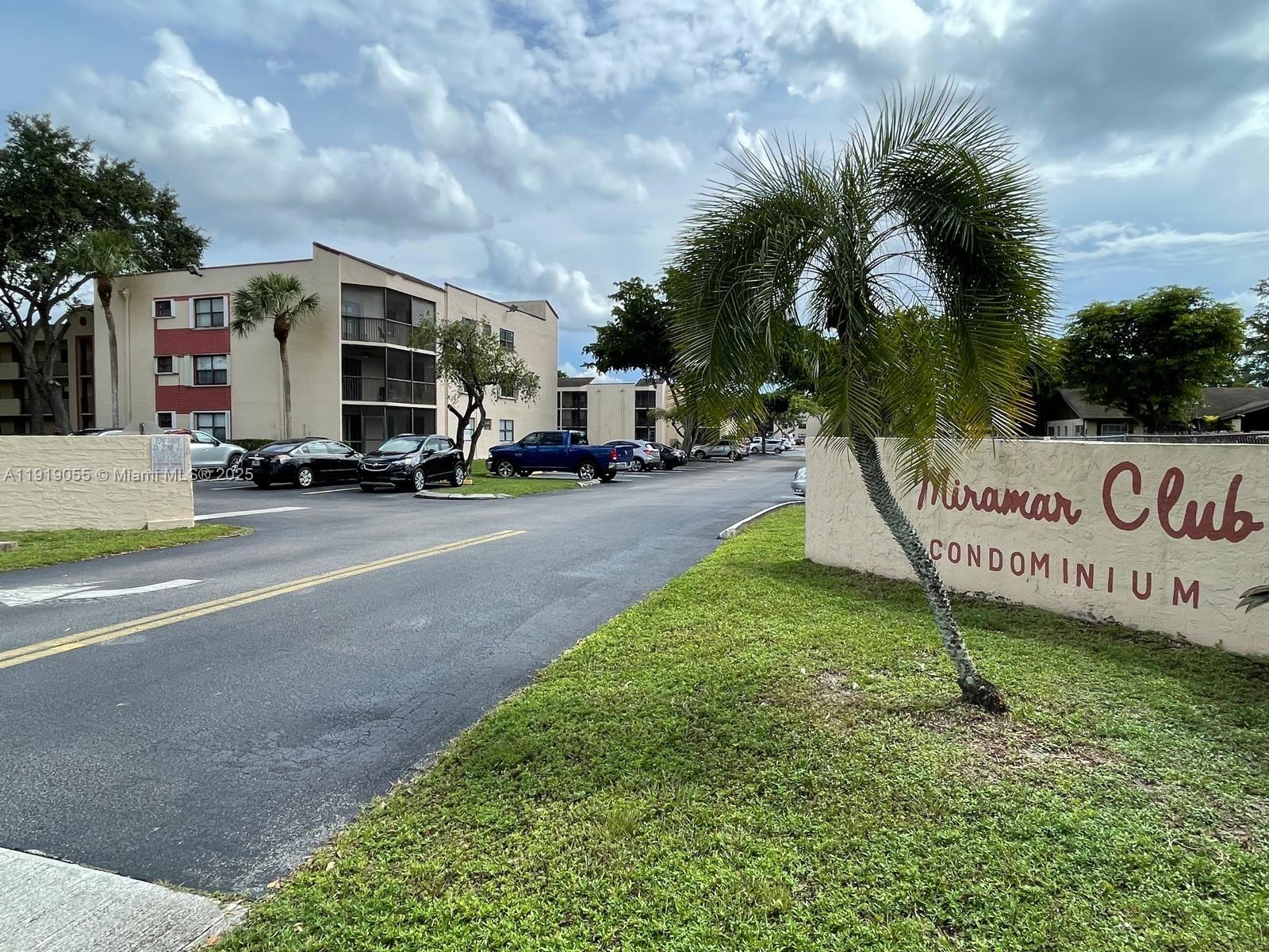 3410 Foxcroft Road, Unit 310 Miramar, FL 33025 - Photo 20 of 21 a view of street with parked cars