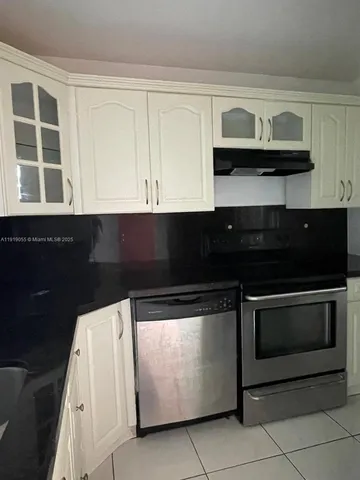 a kitchen with stainless steel appliances granite countertop a stove and a microwave