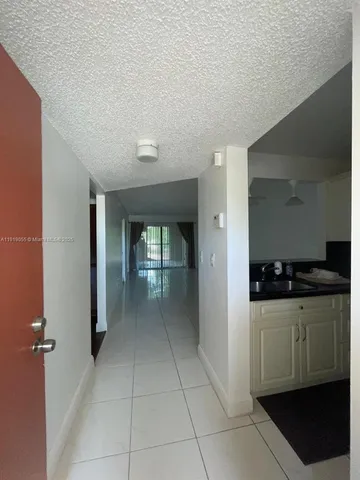 a view of a kitchen with a sink