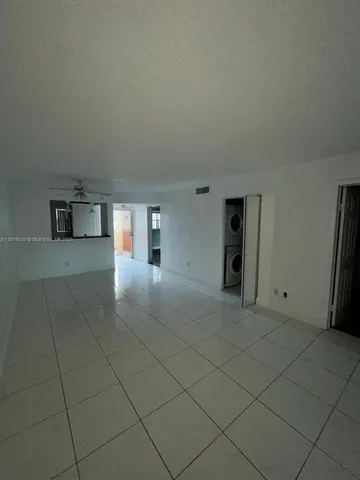 a view of a kitchen with furniture and an empty room
