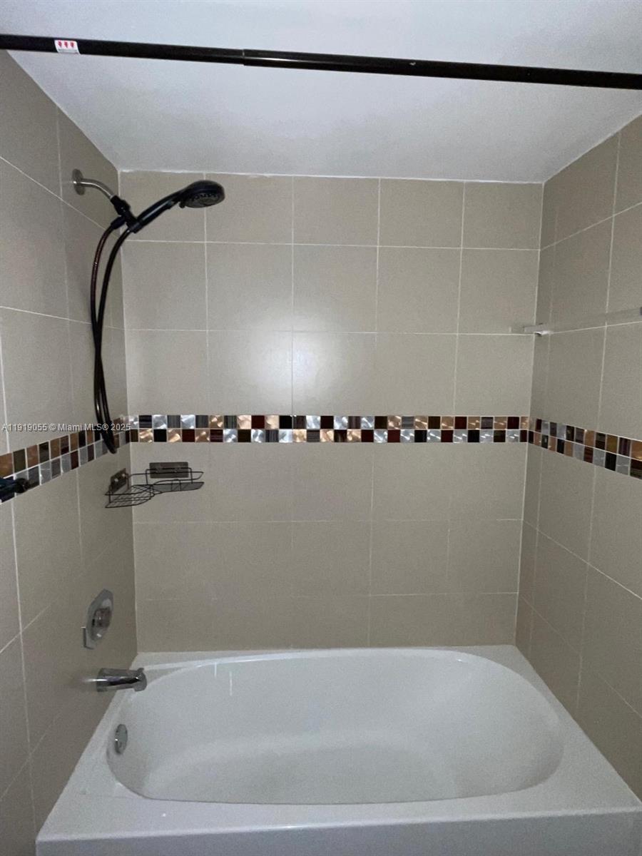 3410 Foxcroft Road, Unit 310 Miramar, FL 33025 - Photo 9 of 21 a bathroom with a bathtub