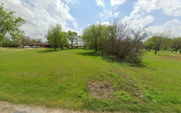 a view of a field with an trees