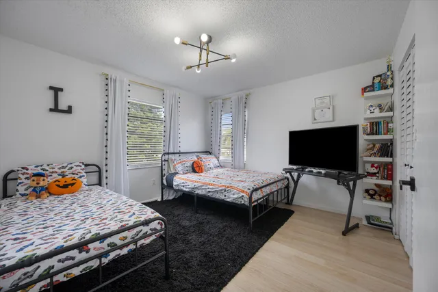 a bedroom with furniture and a flat screen tv