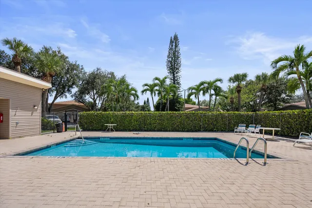 a view of a house with a yard and potted plants