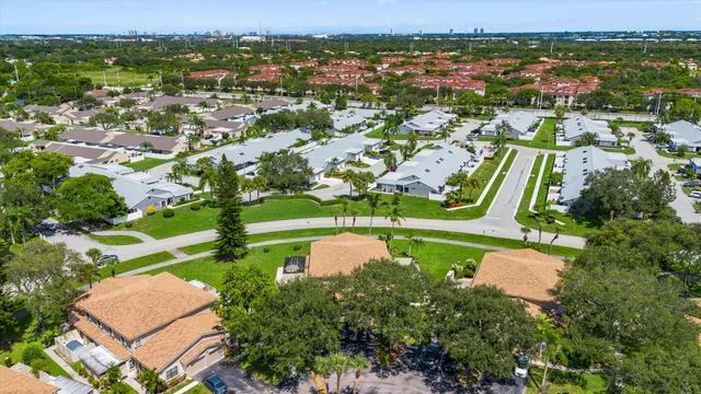 an aerial view of residential houses with outdoor space and parking