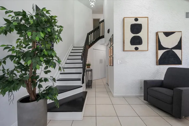 a living room with furniture and a potted plant