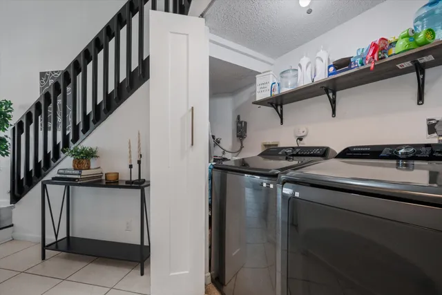 a kitchen with stainless steel appliances granite countertop a refrigerator and a stove