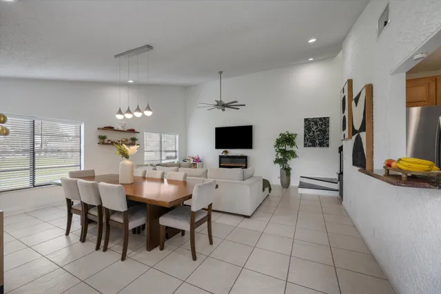 a view of a dining room with furniture and a flat screen tv