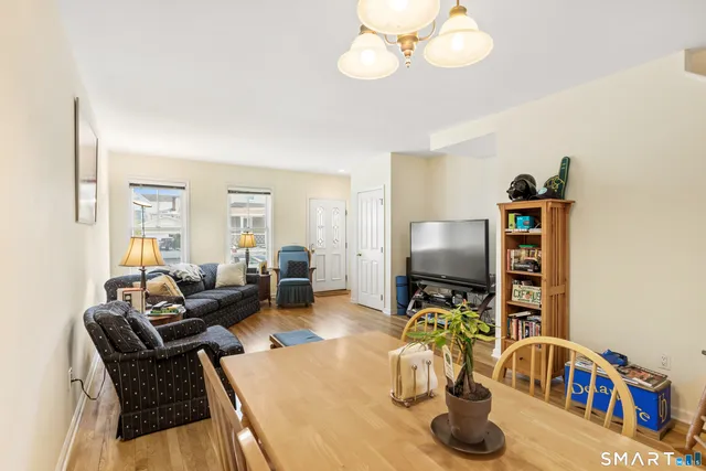 a living room filled with furniture and a chandelier
