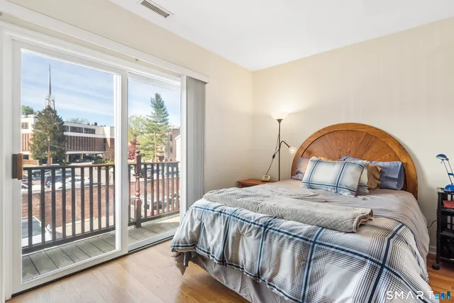 a bedroom with a bed and a large window