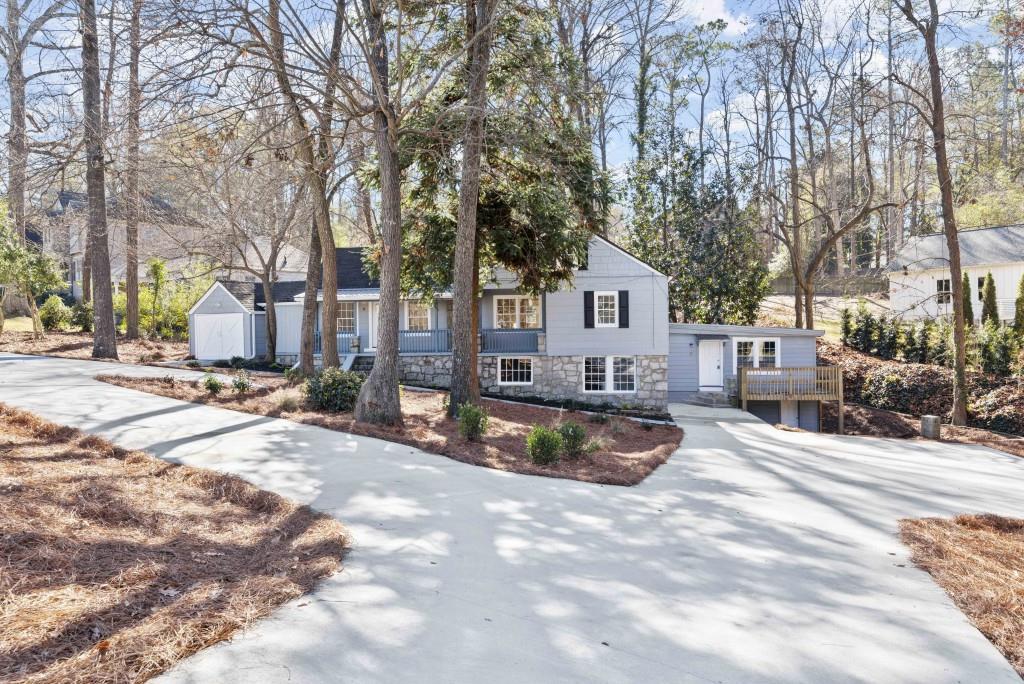 a view of a house with snow on the road