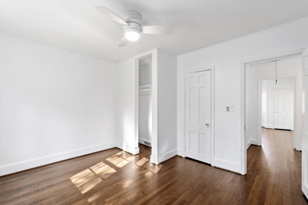 3310 East Roxboro Road Northeast Atlanta, GA 30324 - Photo 12 of 47 an empty room with wooden floor