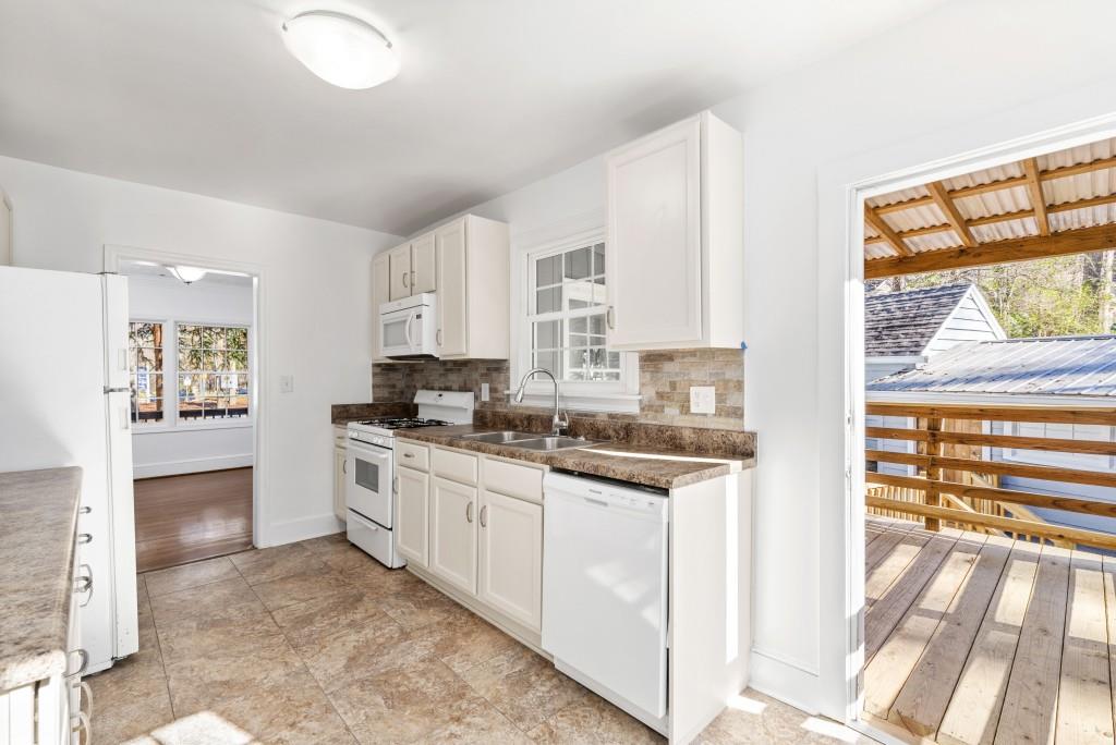 3310 East Roxboro Road Northeast Atlanta, GA 30324 - Photo 14 of 47 a kitchen with stainless steel appliances granite countertop a stove and a sink