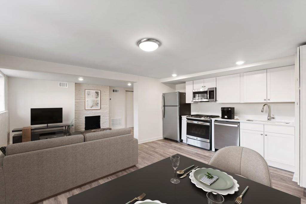 3310 East Roxboro Road Northeast Atlanta, GA 30324 - Photo 23 of 47 a living room with furniture kitchen view and a flat screen tv