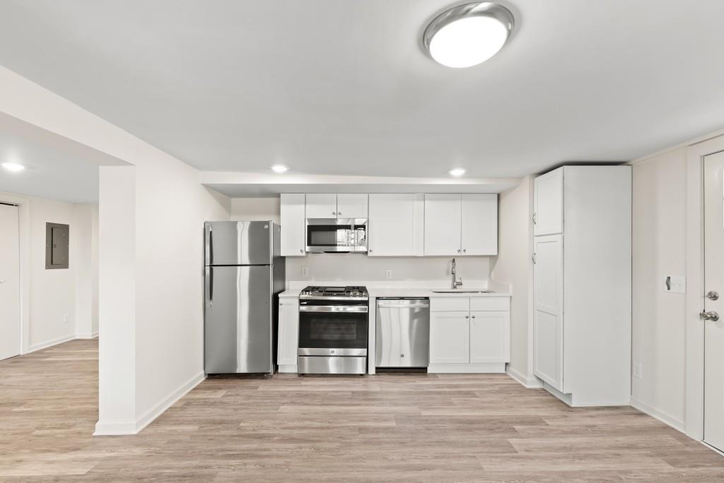 3310 East Roxboro Road Northeast Atlanta, GA 30324 - Photo 24 of 47 a large kitchen with stainless steel appliances granite countertop a stove and a refrigerator