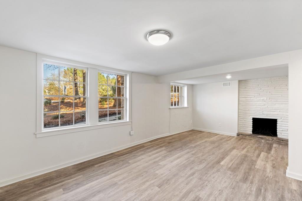 3310 East Roxboro Road Northeast Atlanta, GA 30324 - Photo 26 of 47 a view of empty room with wooden floor and fireplace